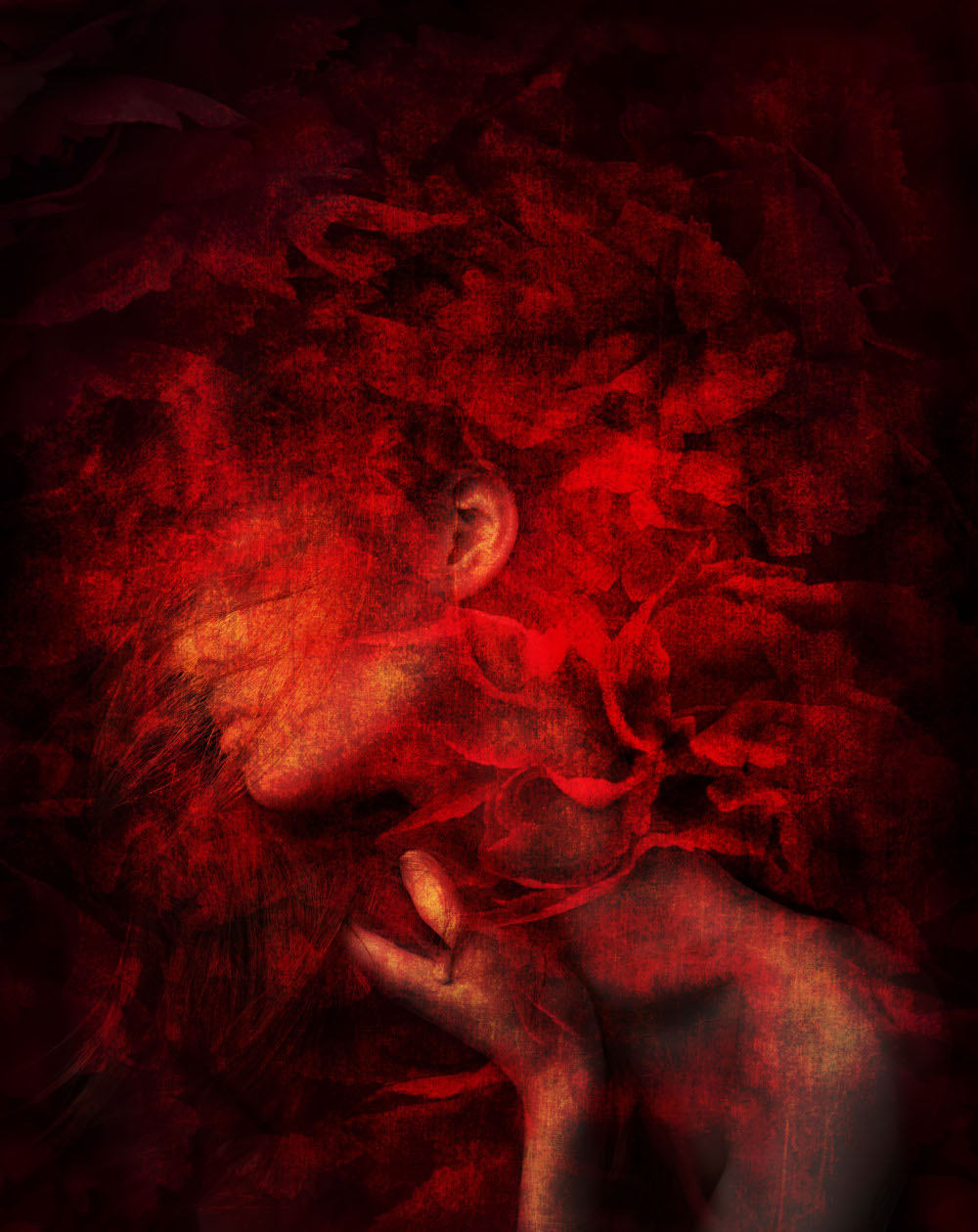 A woman is covered in red flowers and vines.